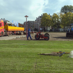 Amsterdam, The Netherlands - October 11, 2018: Professional workers laying new grass rolls in park with special cars and tools